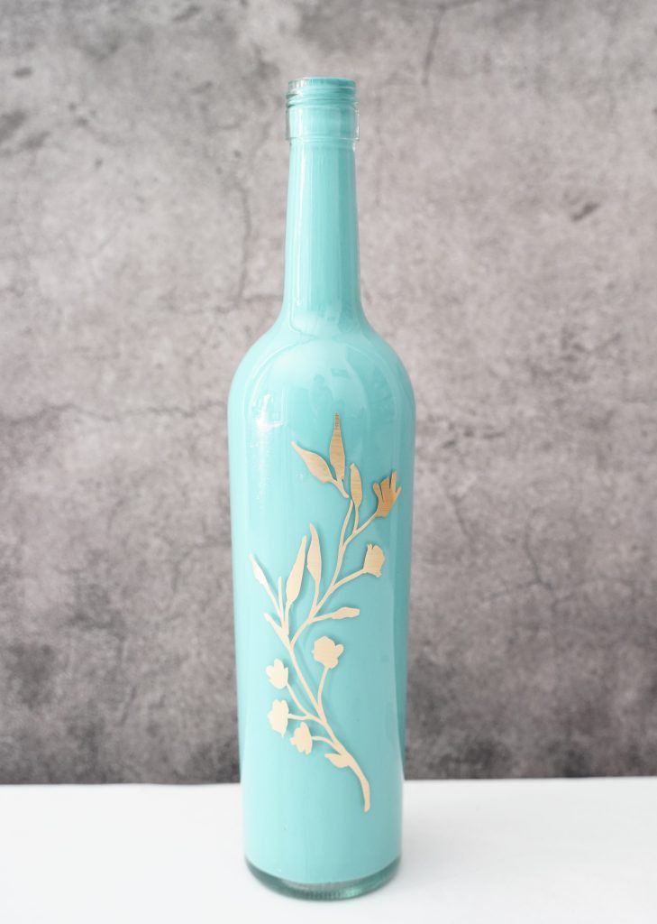 Blue painted bottle with gold floral decal