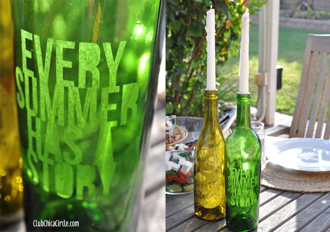 Etched wine bottles used as candle sticks on an outdoor table