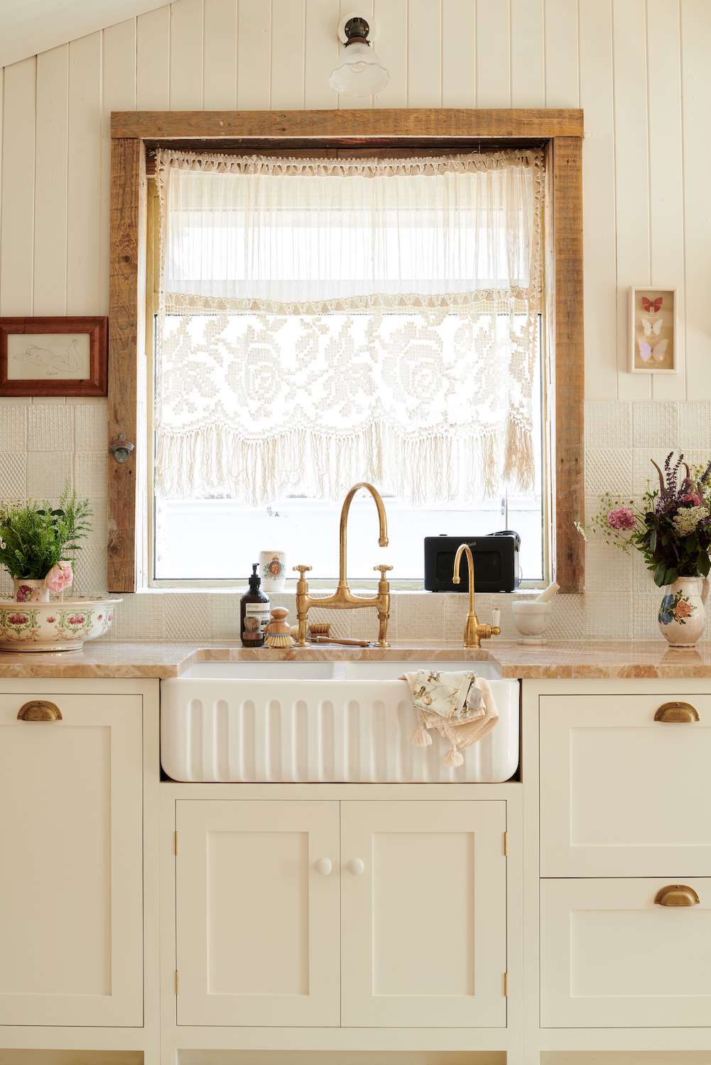 creamy white kitchen cabinets with pink marble countertops