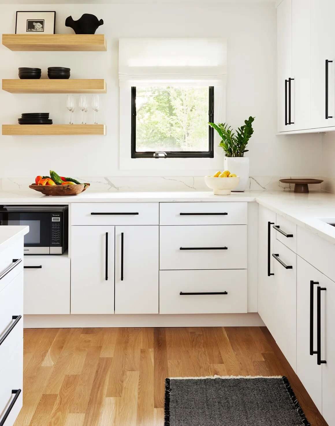 modern white kitchen cabinets with black hardware