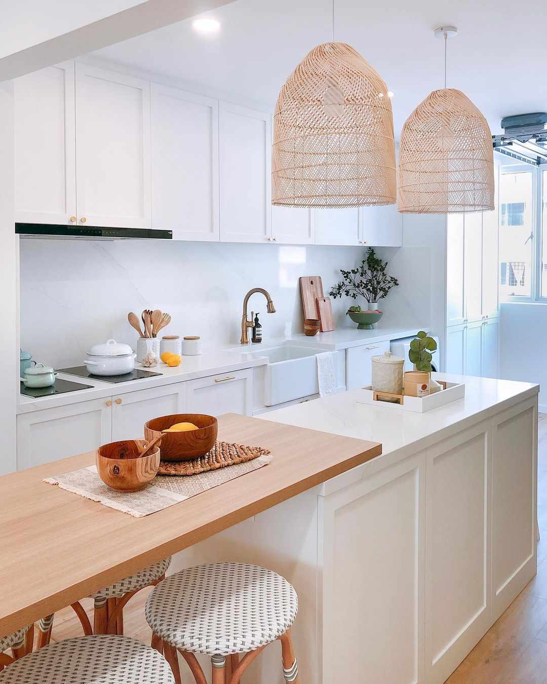 A white kitchen island with a wood countertop extension