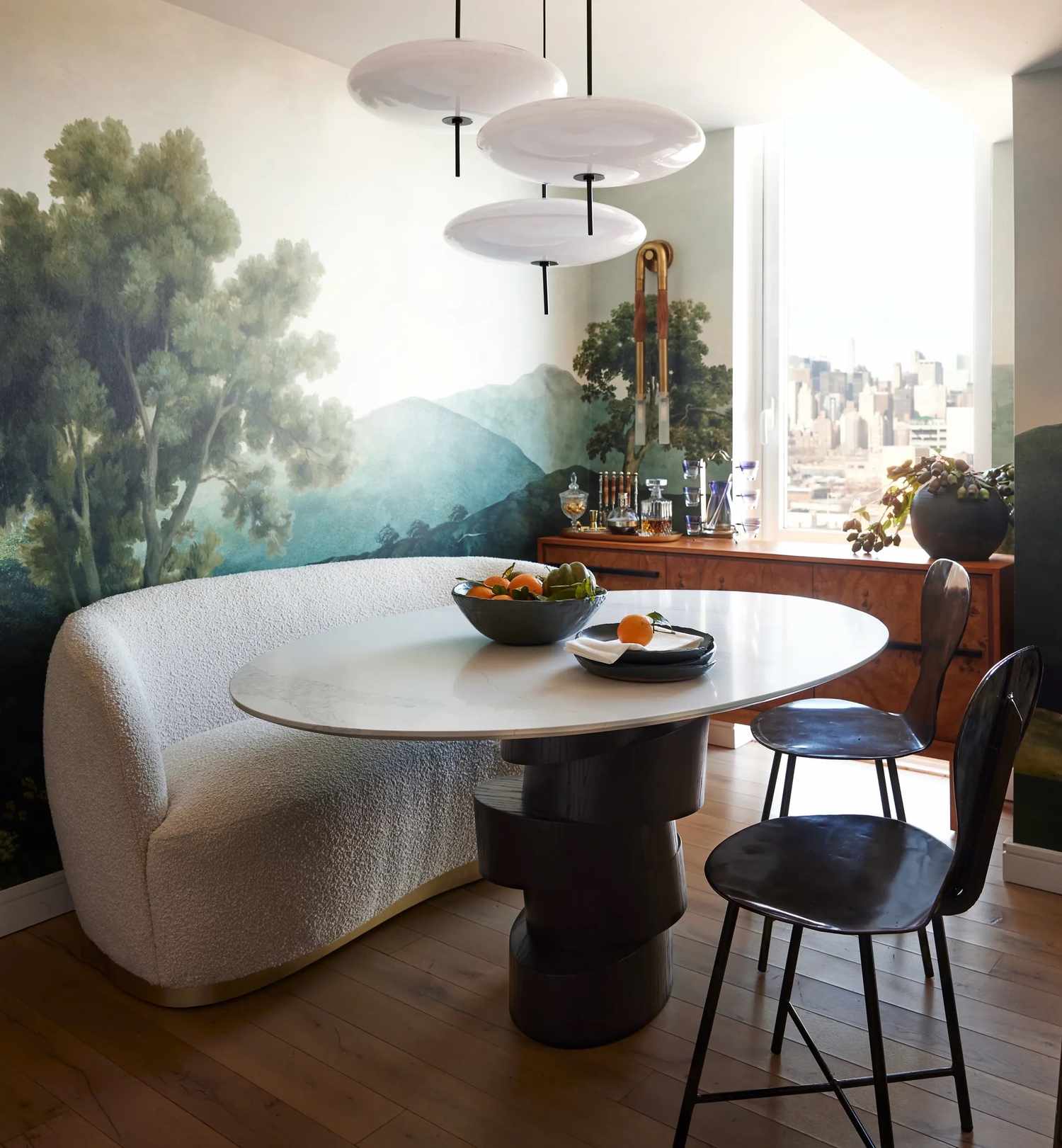 Dining room with green mural wallpaper.