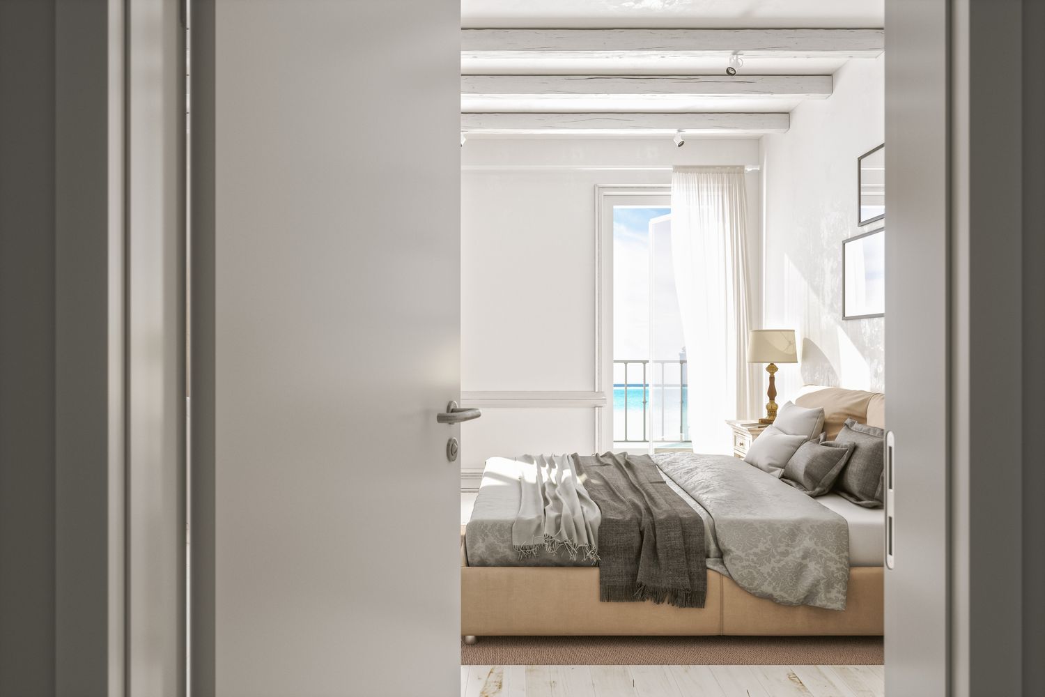 Open door to an empty modern bedroom with ocean view.