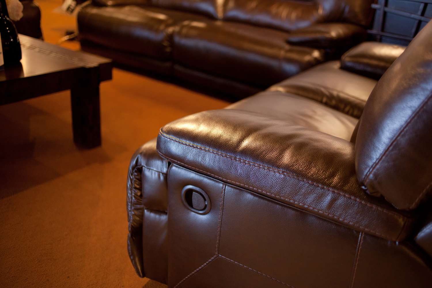 BRown leather reclining sofas, side angle