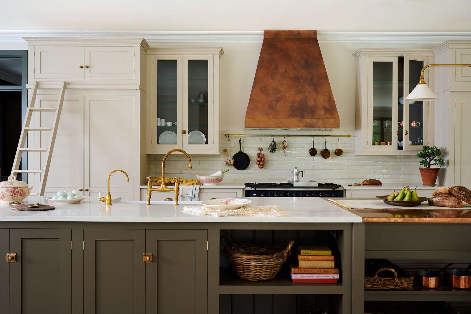 olive green kitchen cabinets with polished brass hardware