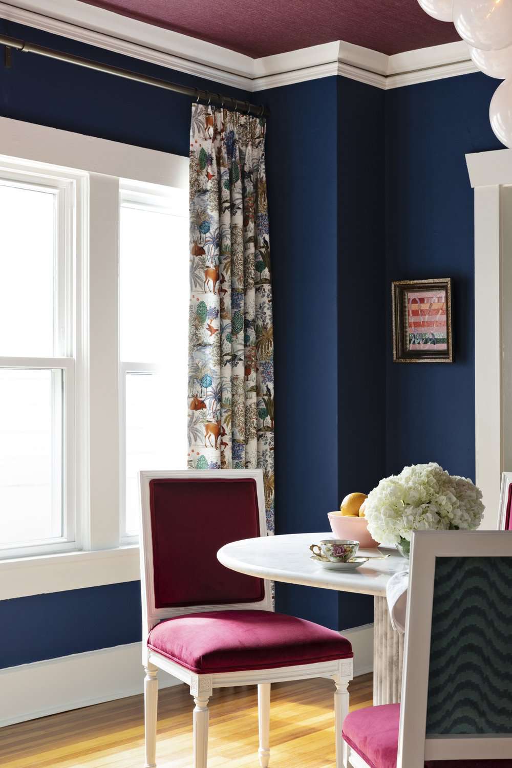 blue dining room with patterned curtains