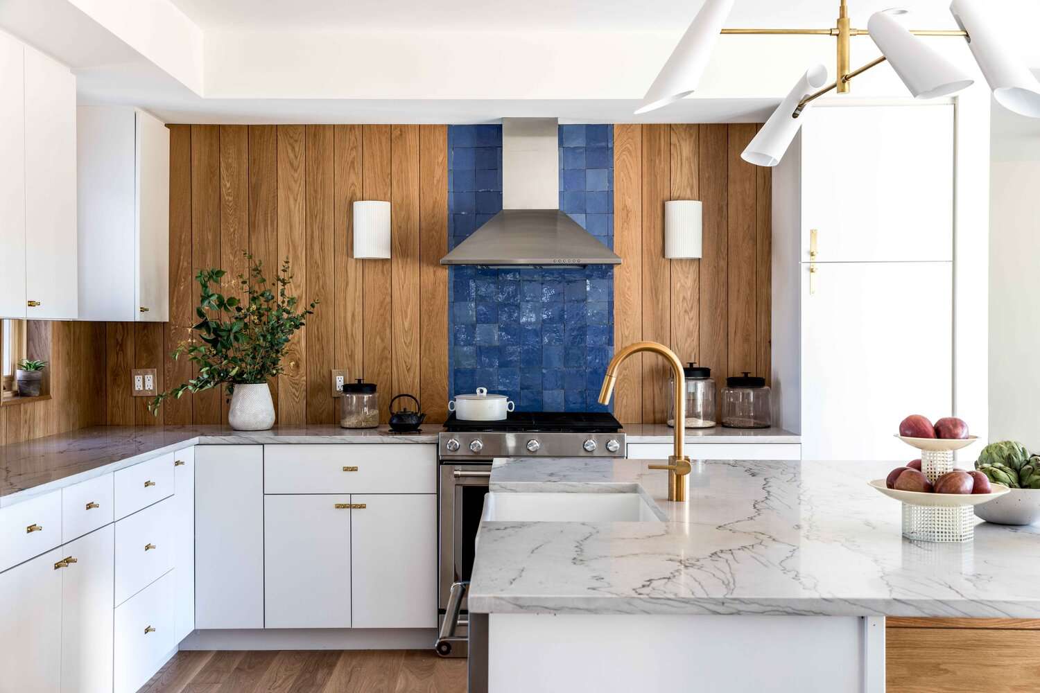 coastal white kitchen cabinets with wood paneled walls