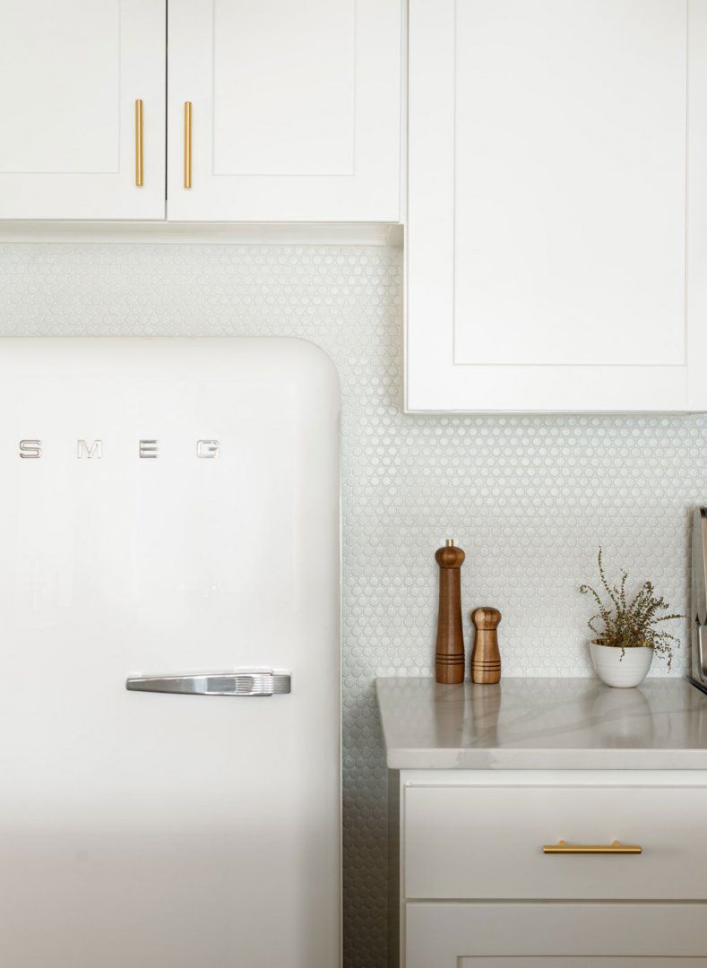 white kitchen cabinets with penny tile backsplash