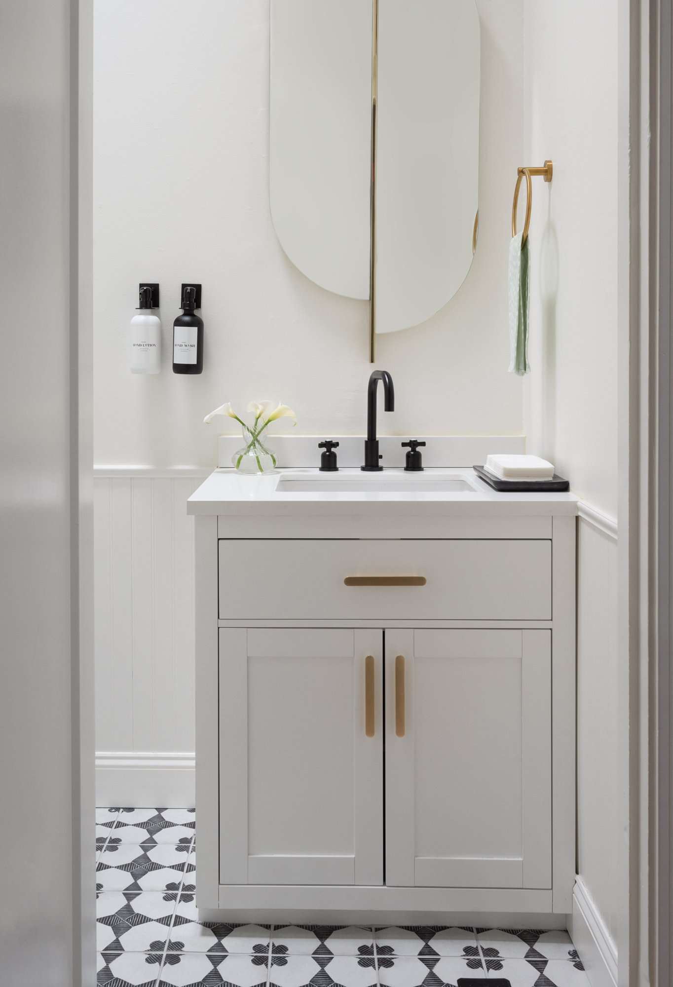 white cabinets and black and white tile