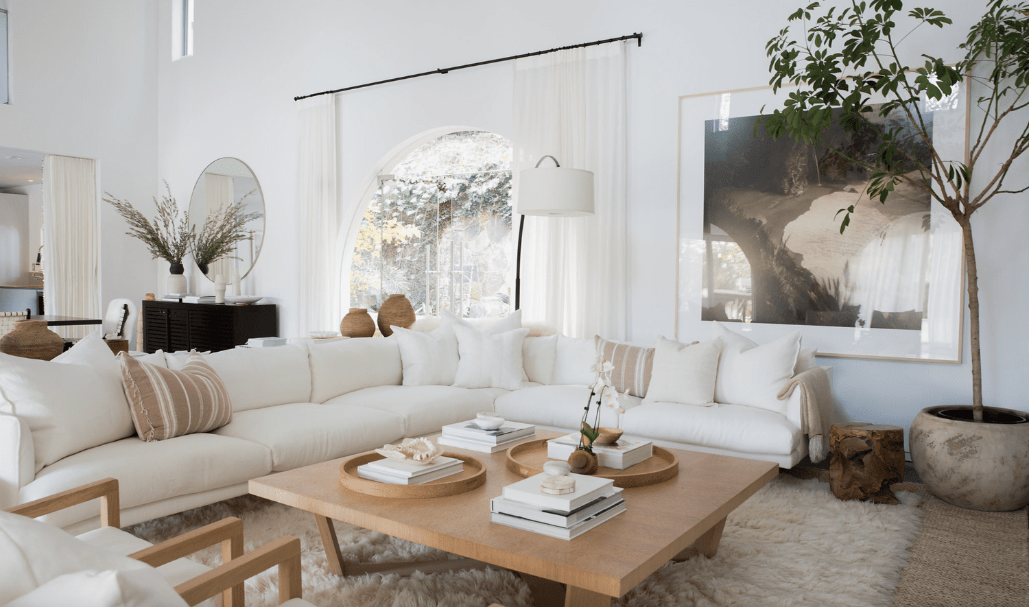 White coastal inspired living room with white sectional sofa and modern oak coffee table