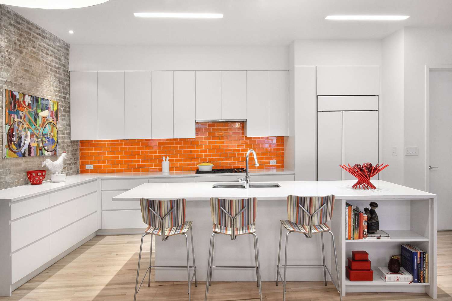 white kitchen cabinets with bright orange subway tile backsplash