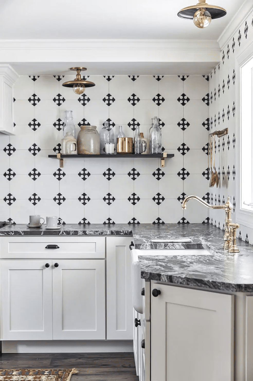 kitchen with white cabinets, marble countertops, and black-and-white tile backsplash